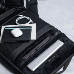 Scapade AirPack laptop and tablet compartments, with a passport wallet and a cable on top