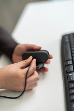 SunBooster held in hand with its USB-C cable, showing its size